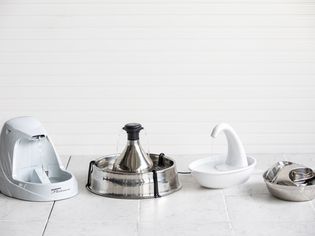 Assortment of best cat water fountains displayed on tile floor