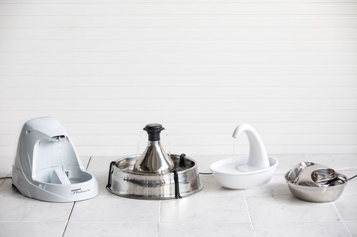 Assortment of best cat water fountains displayed on tile floor